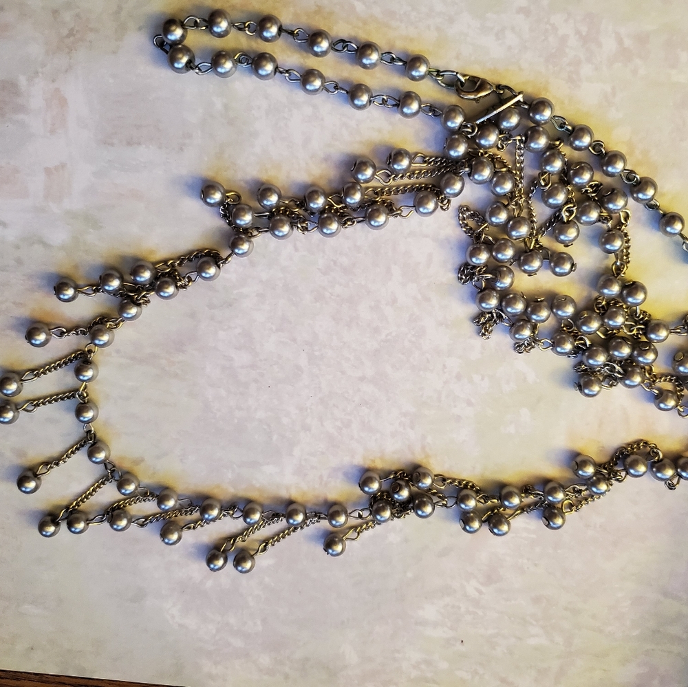 Long grey necklace. Costume jewelry.